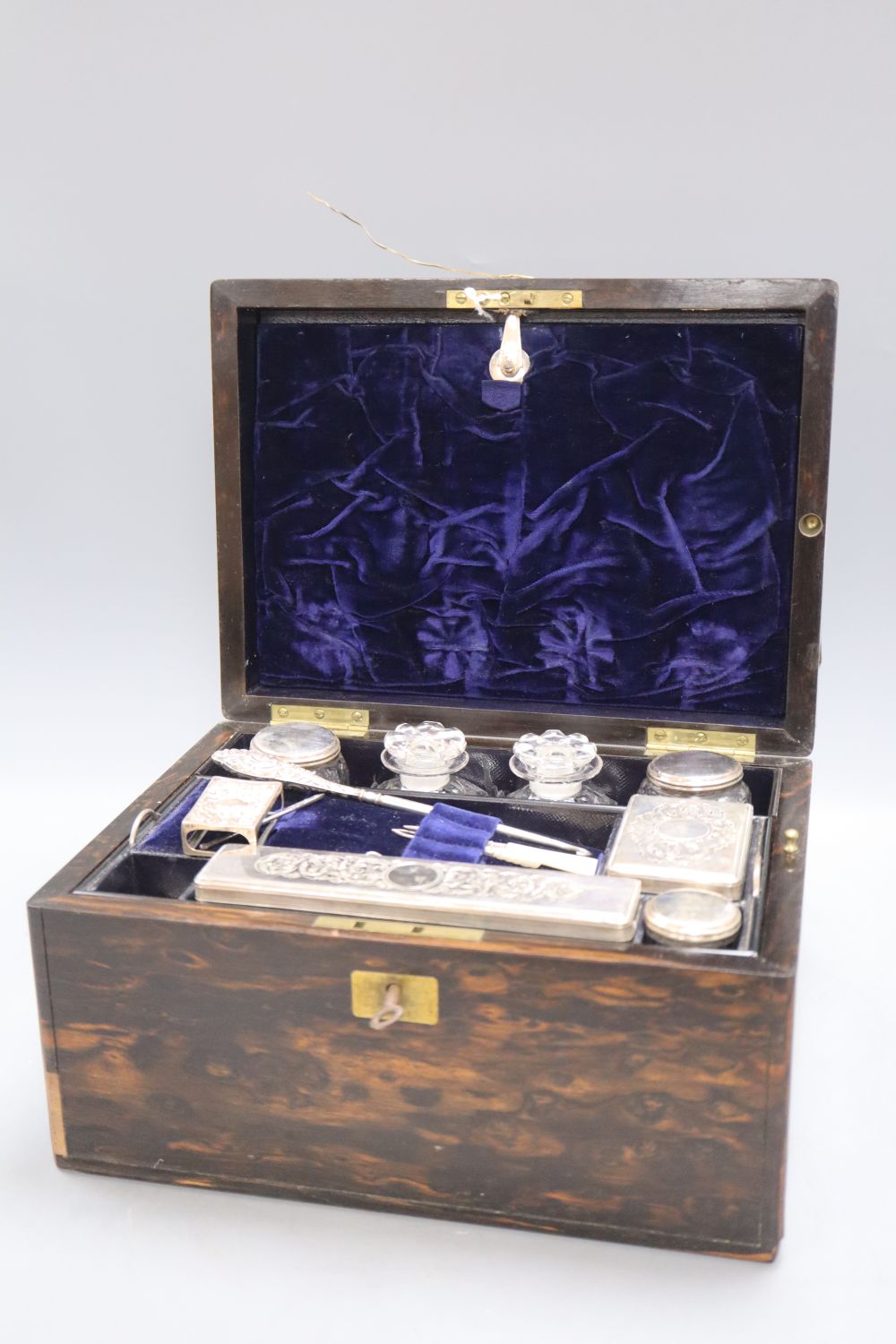 A 19th century brass inlaid coromandel wood travelling toilet box, with plate mounted interior, height 17cm width 28cm